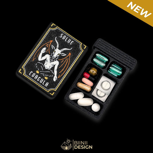 Baphomet artistic pillbox with gothic chic design, Swiss-made in Galaxy Black with gold accents, symbolic organizer for daily meds.