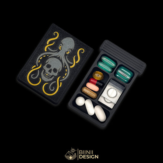 Artistic Kraken pill box in matte black PLA with silver sparkles, featuring skull and tentacles design. Durable, Swiss-made pill organizer. Keywords: kraken pill box, artistic pill organizer, matte black pill case, Swiss design