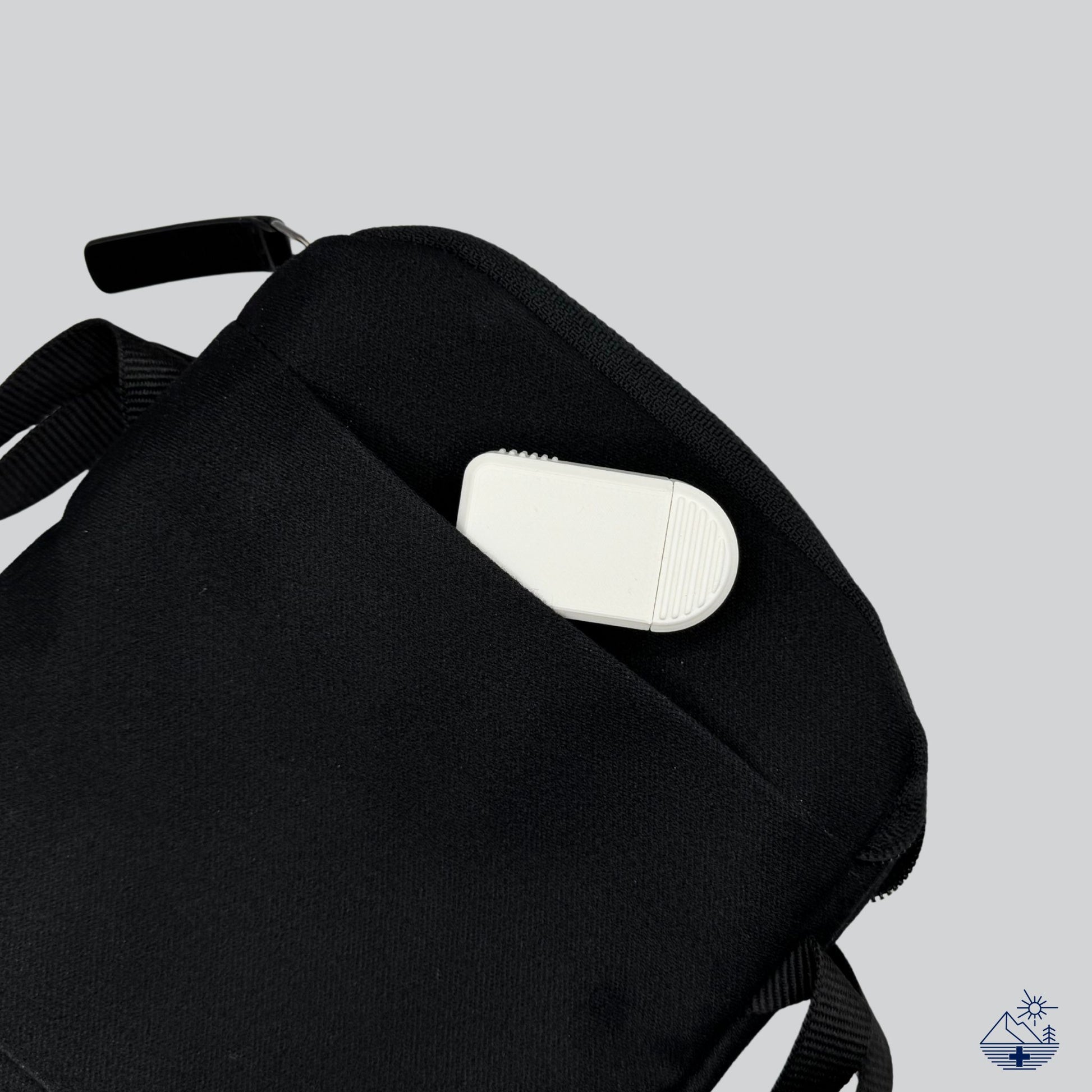 Compact 2-Compartment Pill Organizer (Monochrome White) partially tucked into a travel pouch. Ideal portable medication case for short trips.