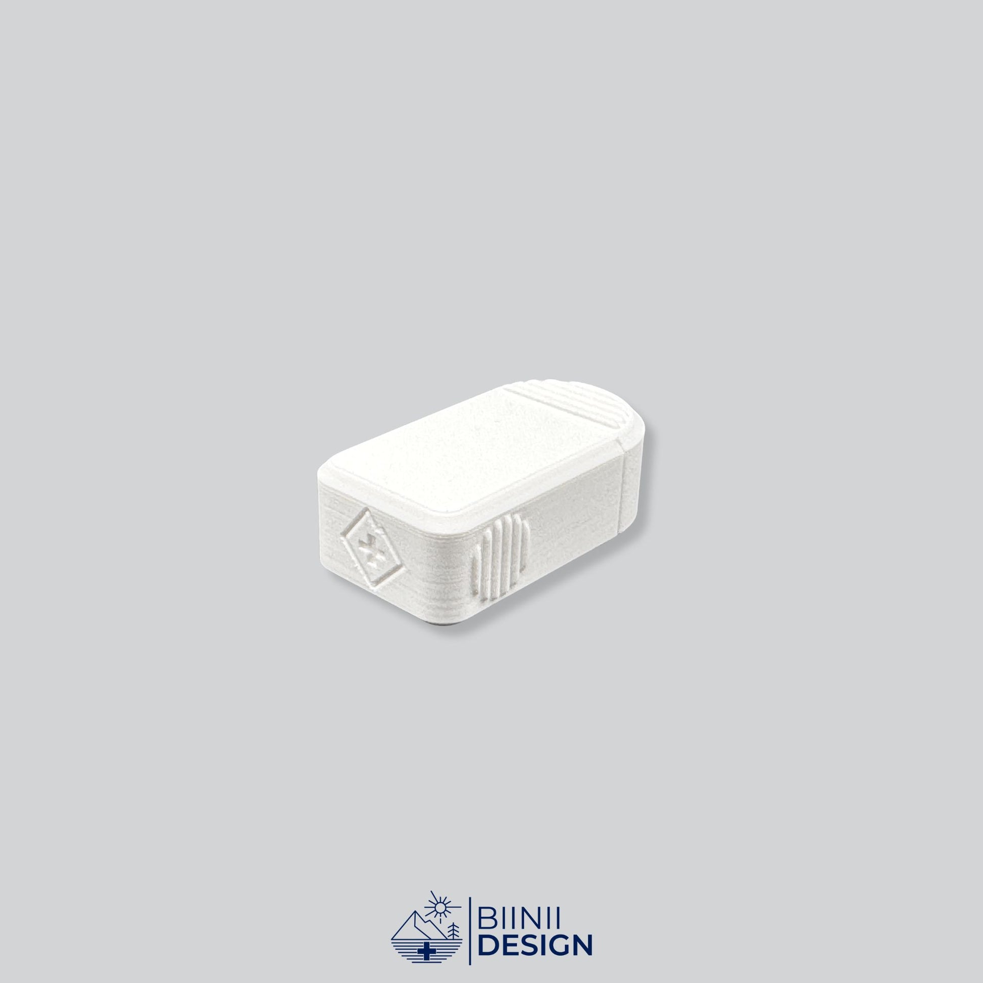 Rear view of the Compact 2-Compartment Pill Case (Monochrome White). Detailed shot showing the discreet Biinii Design logo, Swiss design details, and ergonomic side grooves.