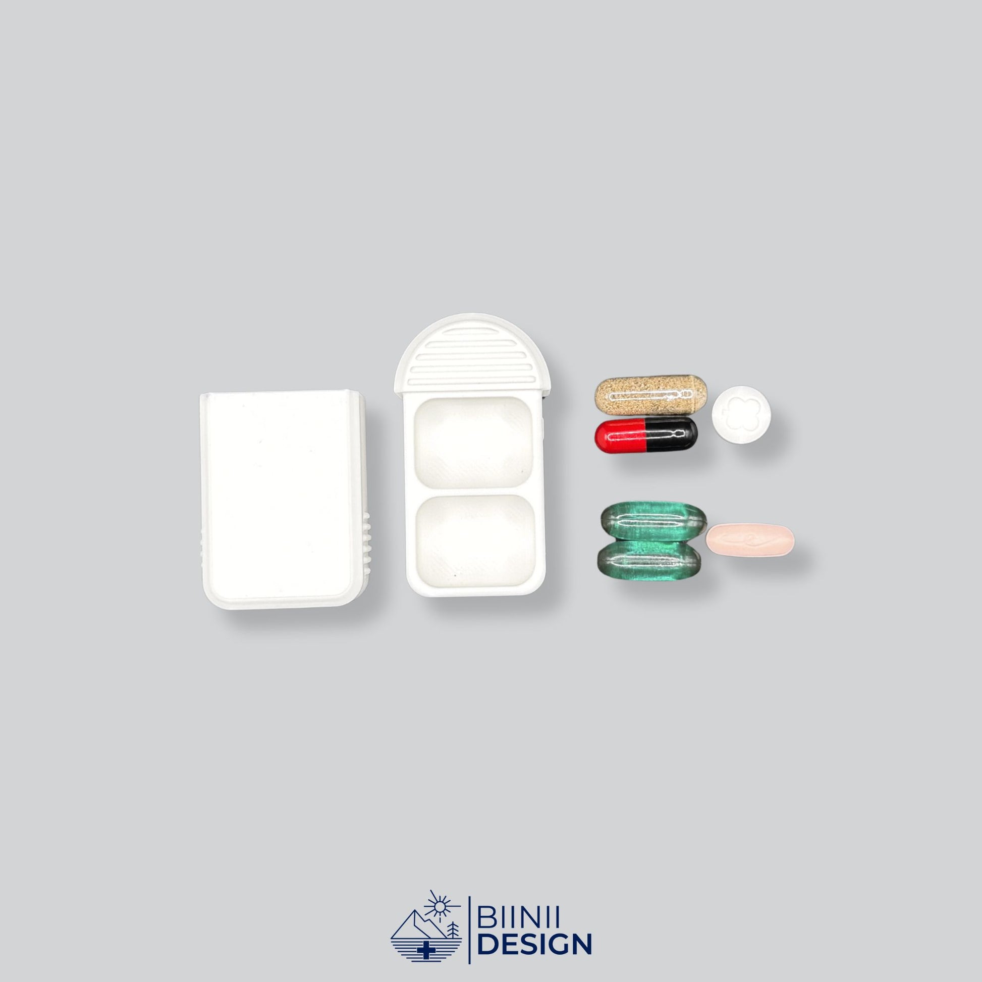 Compact 2-Compartment Pill Case (Monochrome White) shown open next to various medication and supplements (capsules, tablets, anti-allergics). Ideal for daily dose planning and sorting.