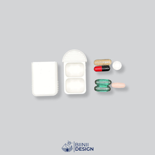 Compact 2-Compartment Pill Case (Monochrome White) shown open next to various medication and supplements (capsules, tablets, anti-allergics). Ideal for daily dose planning and sorting.