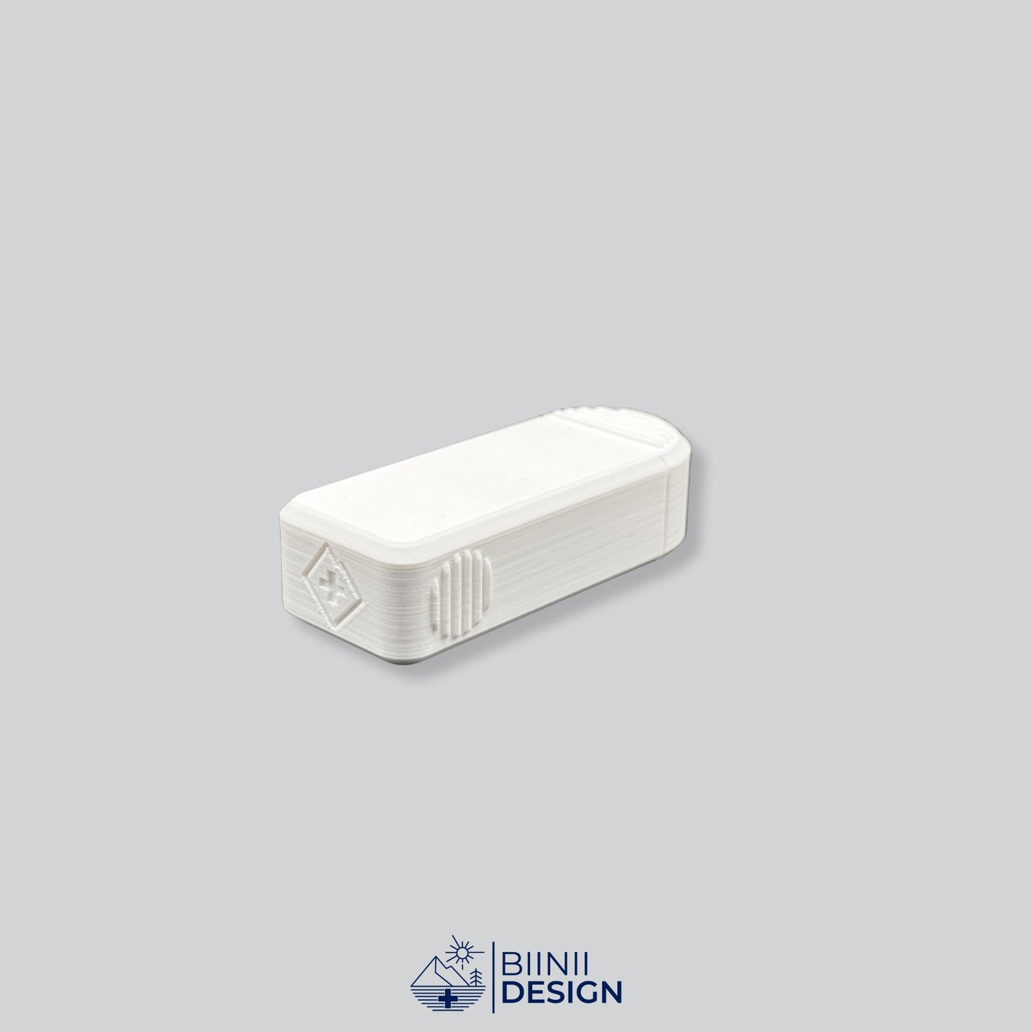 Rear view of the Compact 3-Compartment Pill Case (Monochrome White). Detailed shot showing the discreet Biinii Design logo, Swiss design details, and ergonomic side grooves.