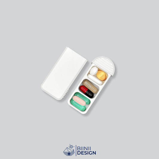 Compact 3-Compartment Pill Box (Monochrome White) opened and filled with various daily medication, vitamins, and supplements. Highlights capacity and versatile usage.