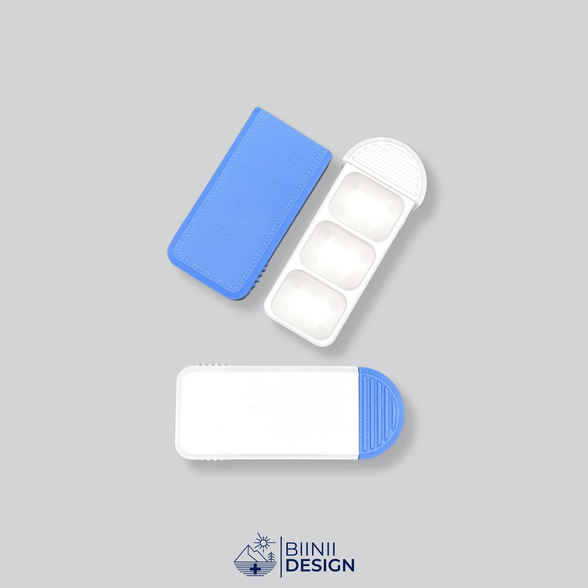 Compact 3-Compartment Pill Organizer (White/Blue Two-Tone). Photo showing one open unit with sliding lid and one closed unit, highlighting the dual color design options.