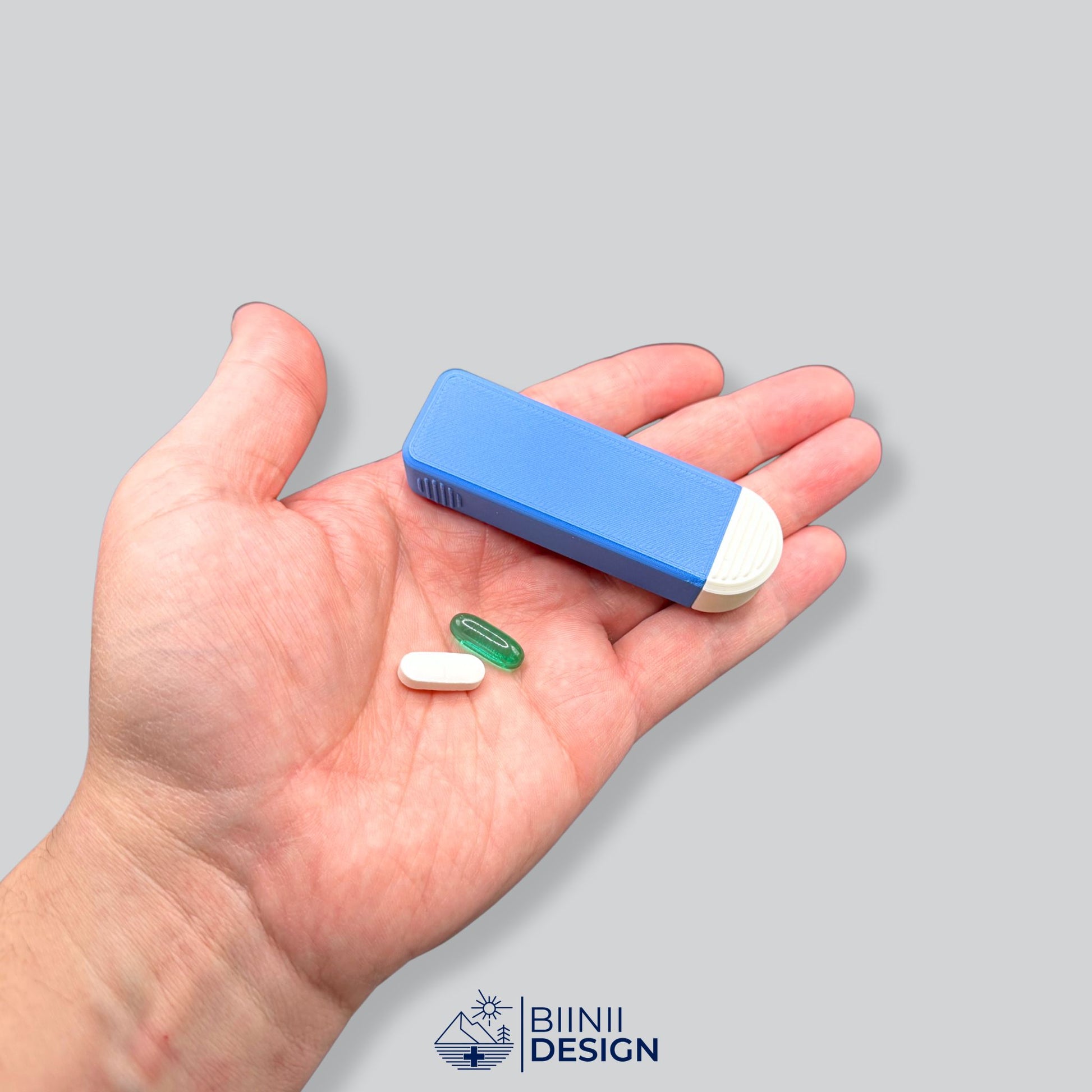 Compact 4-Compartment Pill Organizer (Blue/White Two-Tone) held in hand for scale. Highlights miniature size and discretion for carrying multiple daily doses.