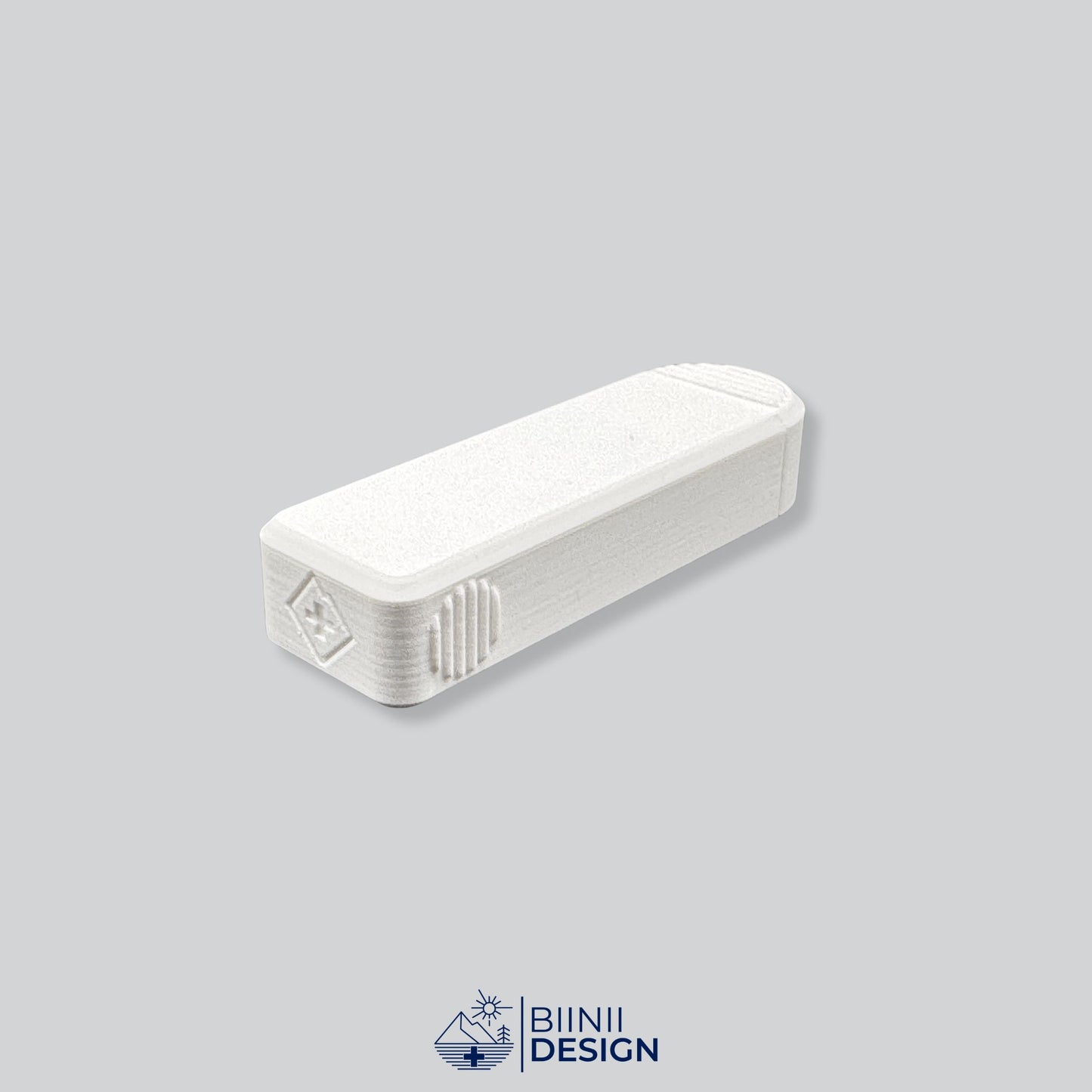 Rear view of the Compact 4-Compartment Pill Case (Monochrome White). Detailed shot showing the discreet Biinii Design logo, Swiss design details, and ergonomic side grooves.