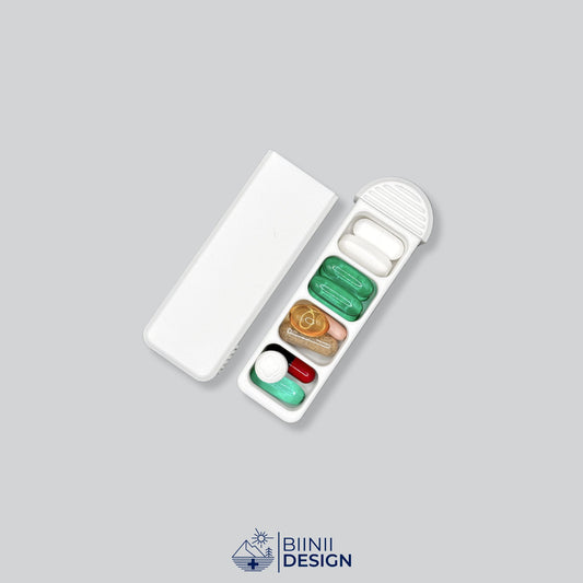 Compact 4-Compartment Pill Box (Monochrome White) opened and filled with various daily medication, vitamins, and supplements. Highlights capacity and versatile usage.
