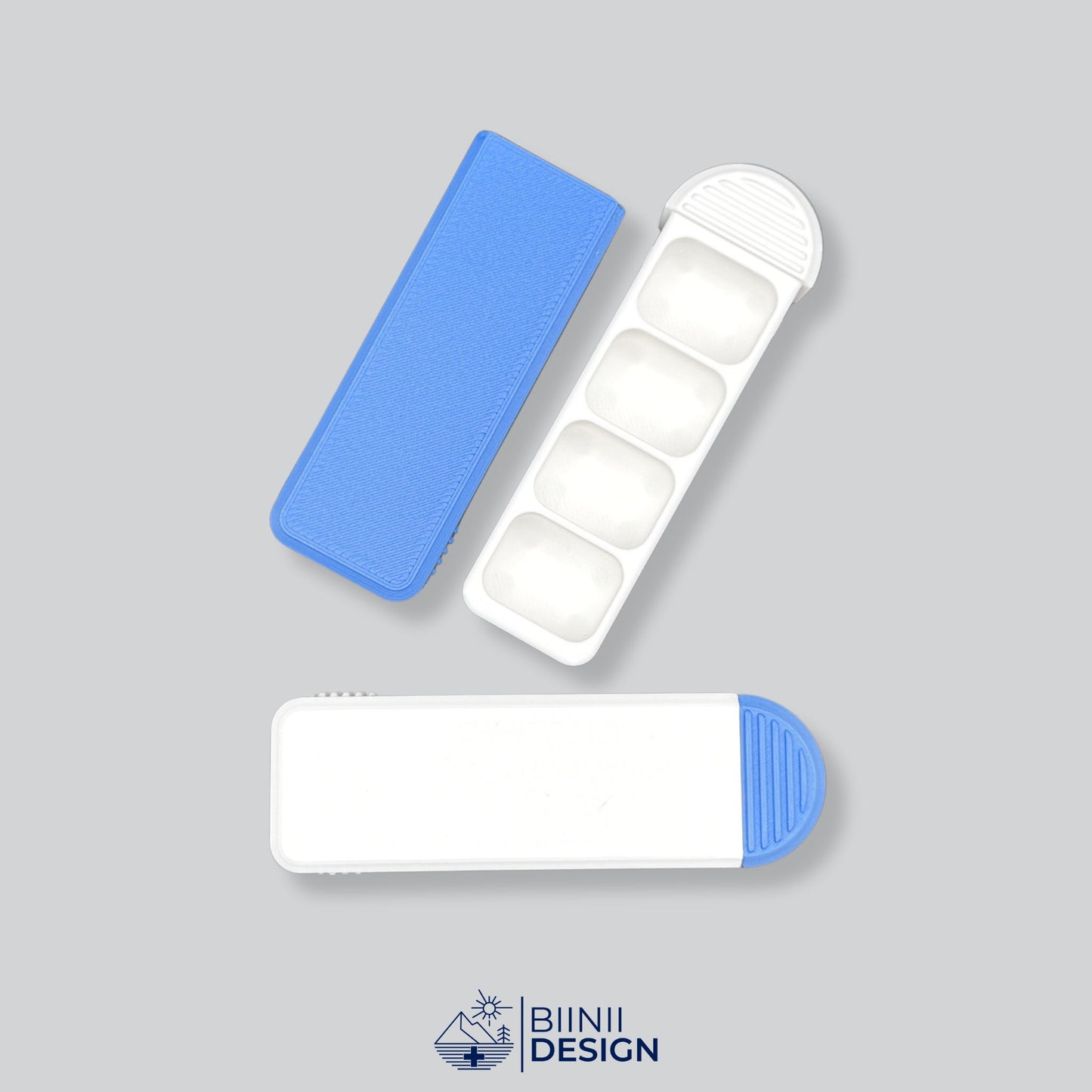 Compact 4-Compartment Pill Organizer (White/Blue Two-Tone). Photo showing one open unit with sliding lid and one closed unit, highlighting the dual color design options.