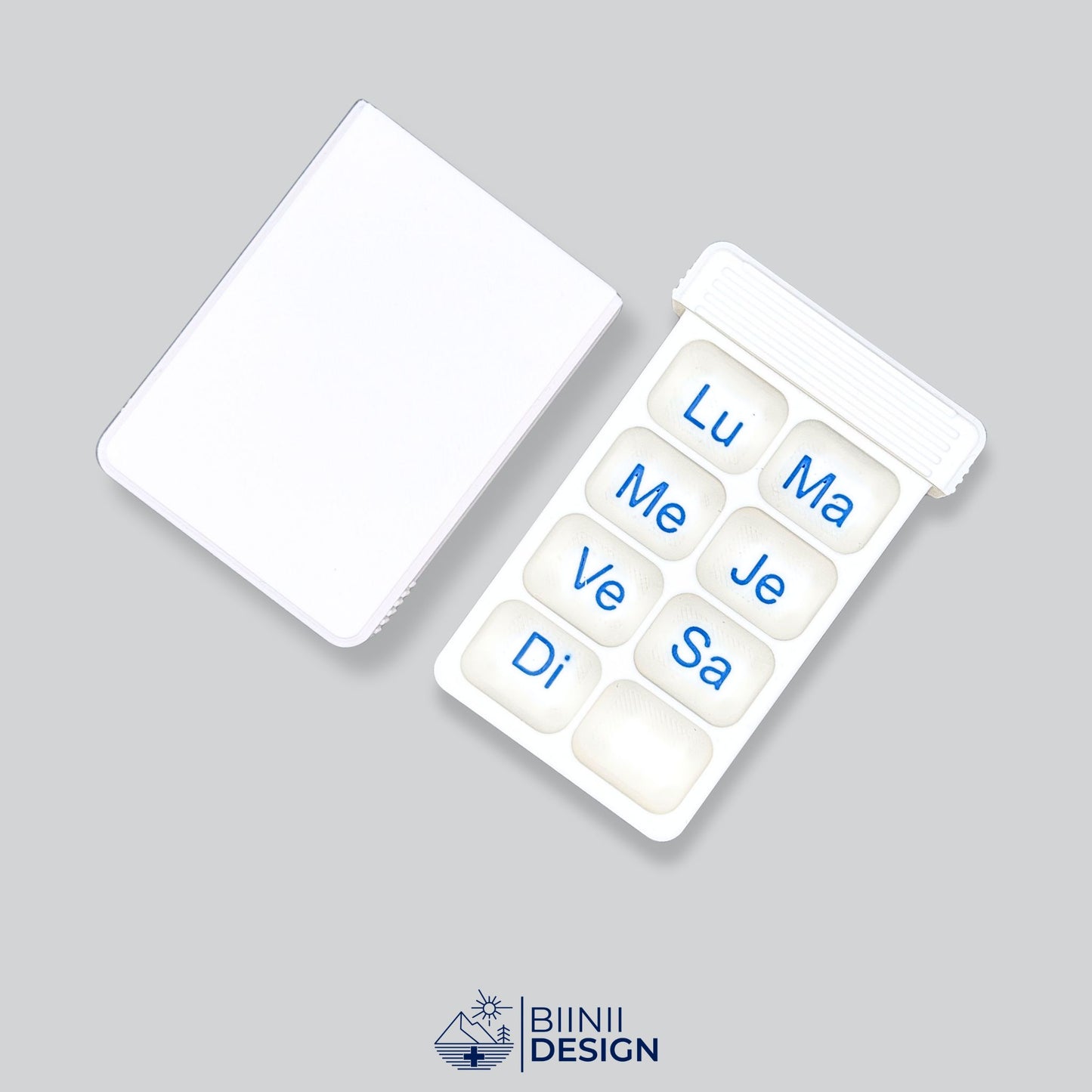 Open compact 7-day pill organizer with seven compartments. Swiss-made daily medication case by Biinii Design, designed for optimal planning.