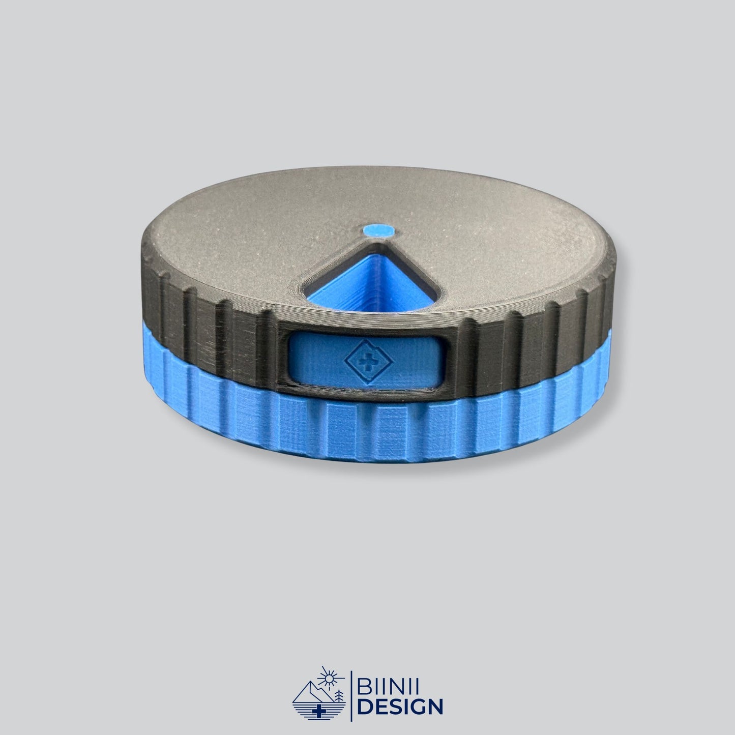 Black lid with blue base; round magnetic 7-day pill organizer.