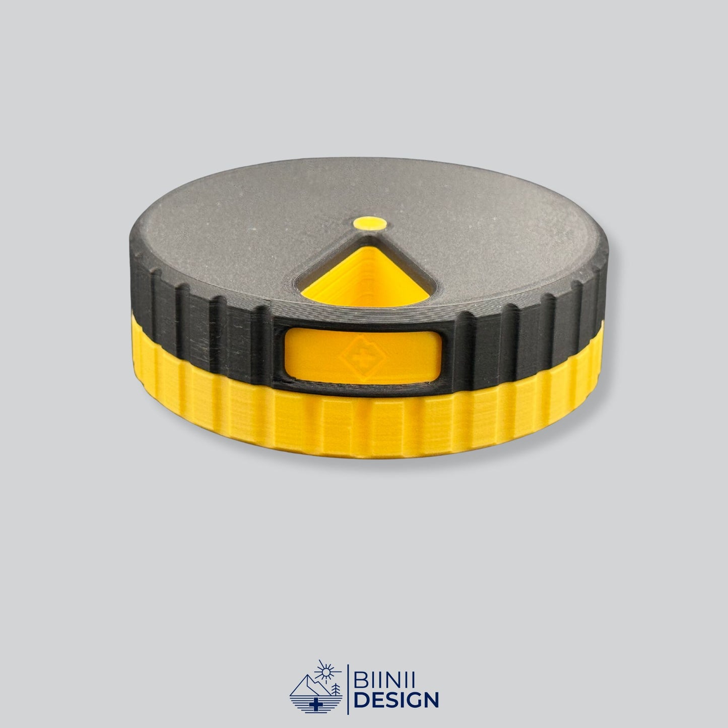 Black lid with yellow base; round magnetic weekly medication organizer.