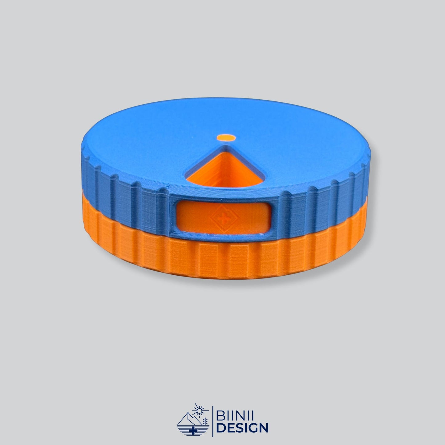 Blue lid with orange base; round magnetic weekly pill box.