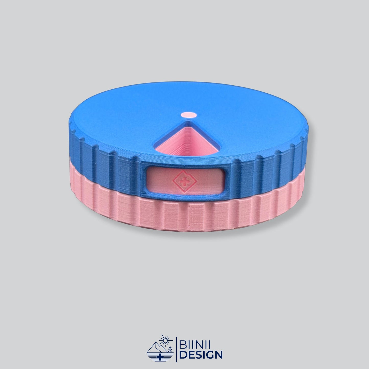Blue lid with pink base; vibrant round 7-day magnetic organizer.
