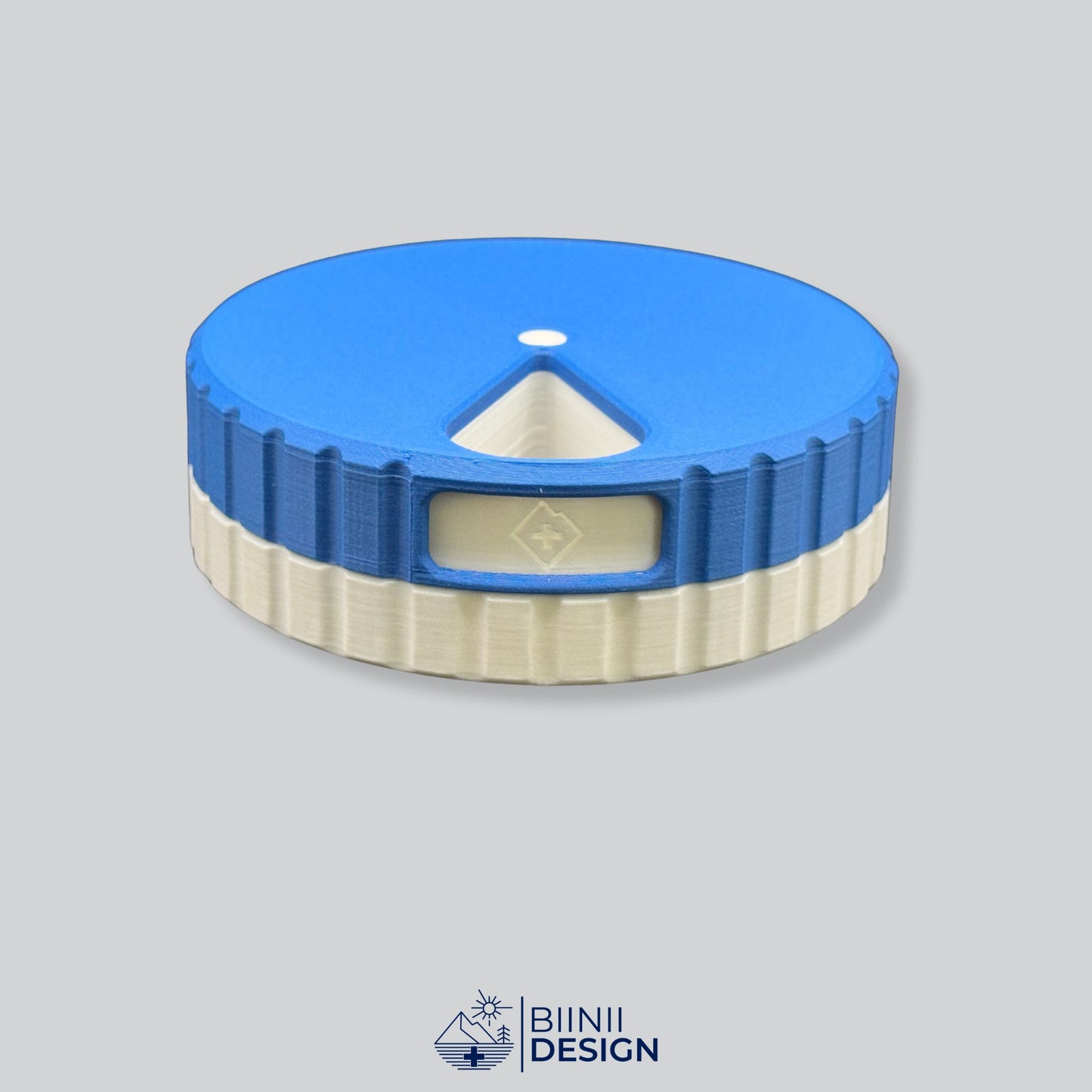 Blue lid with white base; compact 7-day pill organizer.