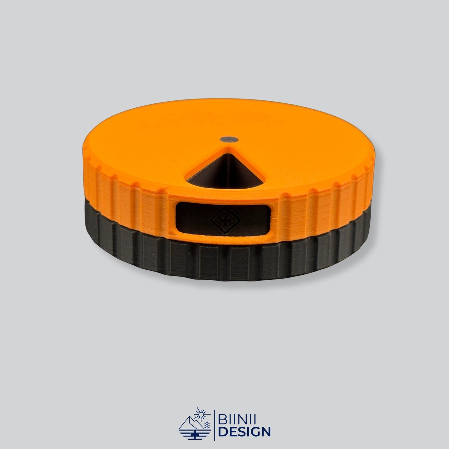 Orange lid with black base; magnetic round 7-day pill organizer.