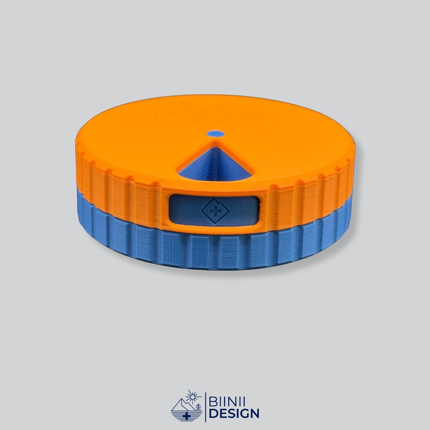 Orange lid with blue base; round magnetic weekly pill box.