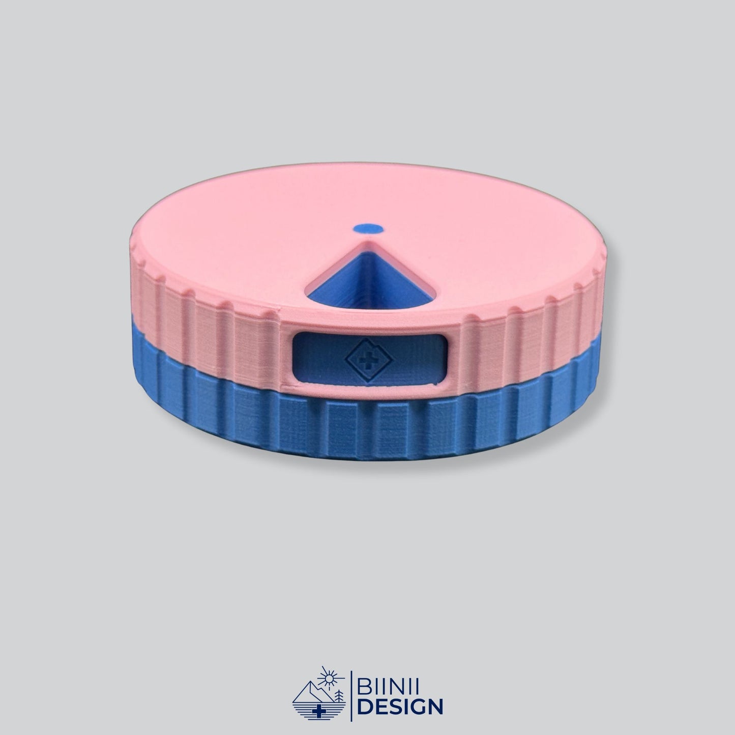 Pink lid with blue base; round magnetic weekly pill case.
