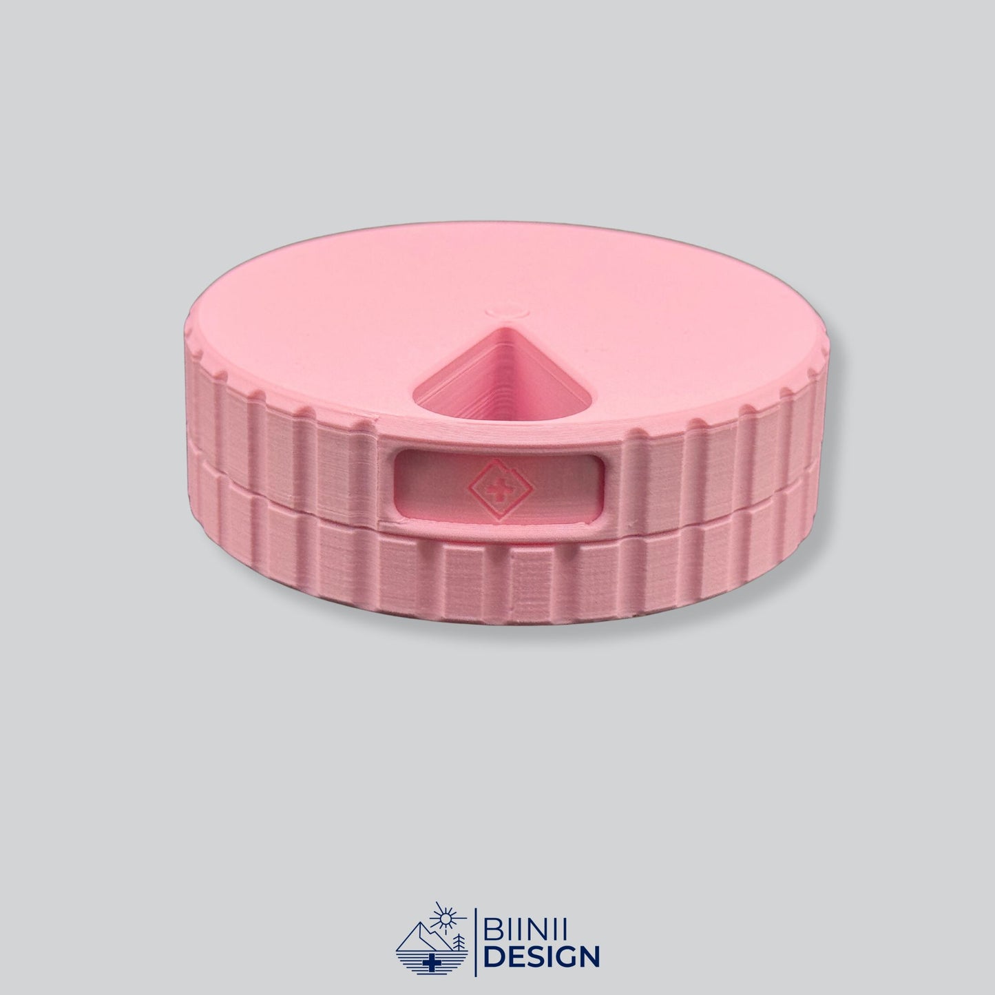 Monochrome pink round magnetic 7-day pill organizer.