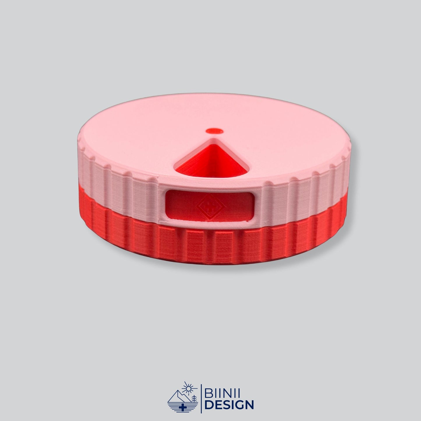 Pink lid with red base; round magnetic weekly pill box.