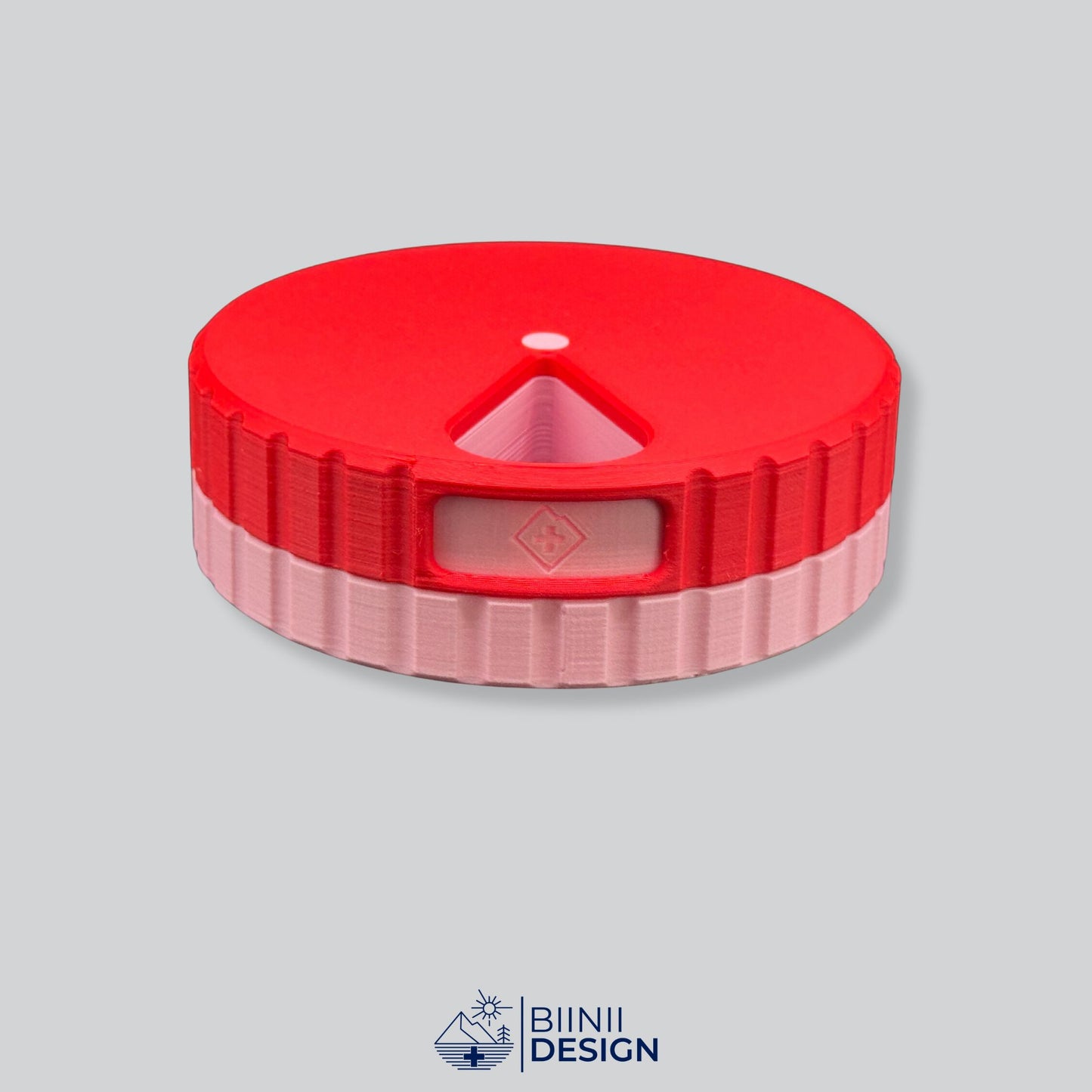 Red lid with pink base; round magnetic 7-day pill case.