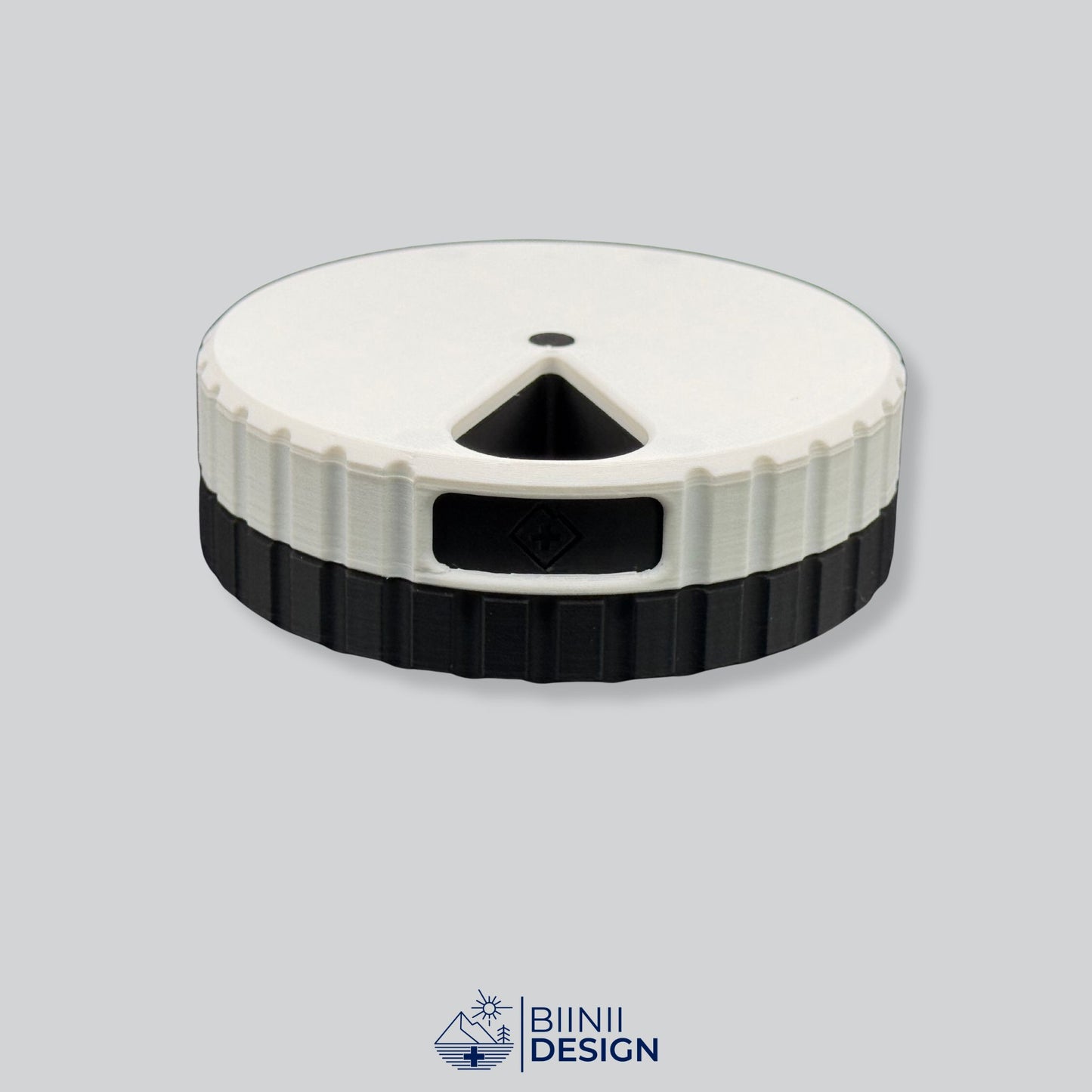 White lid with black base; magnetic round 7-day pill organizer.