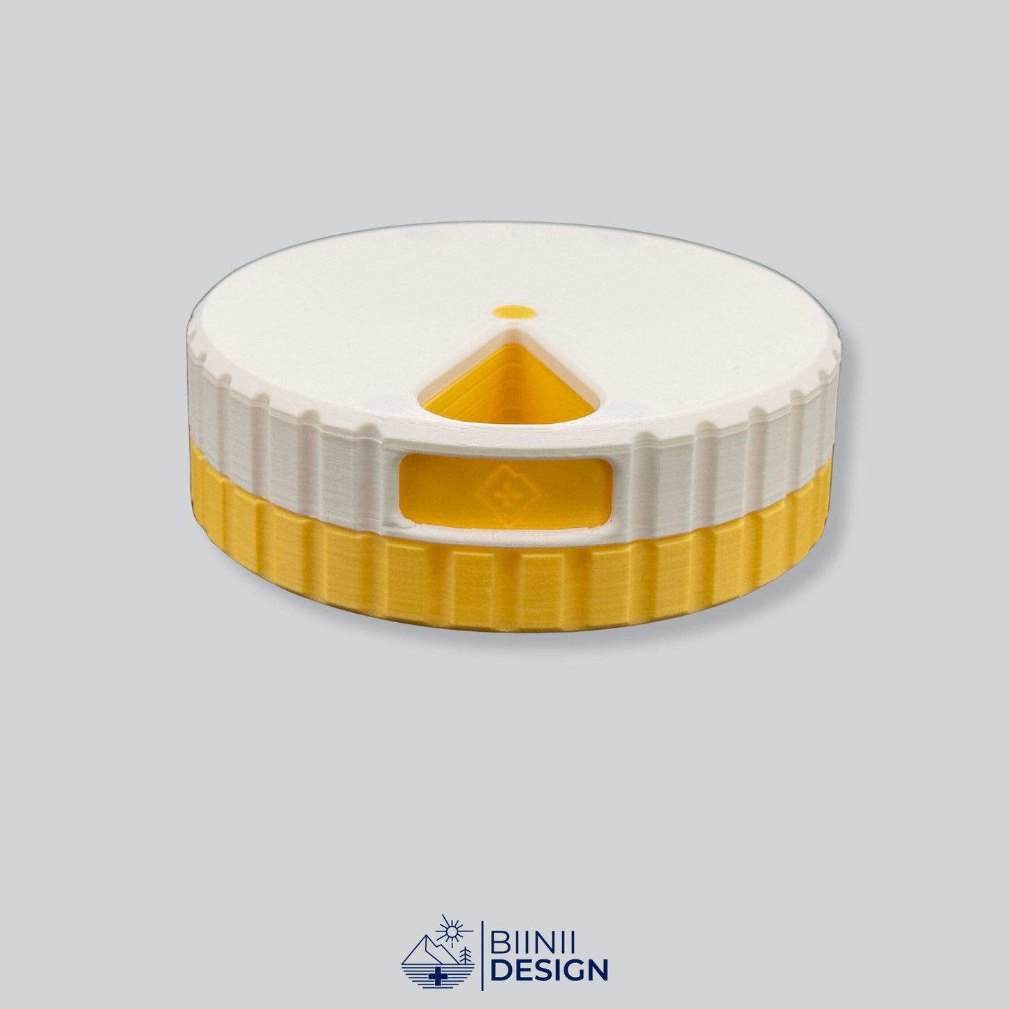 White lid contrasting with yellow base. Round magnetic pill organizer.