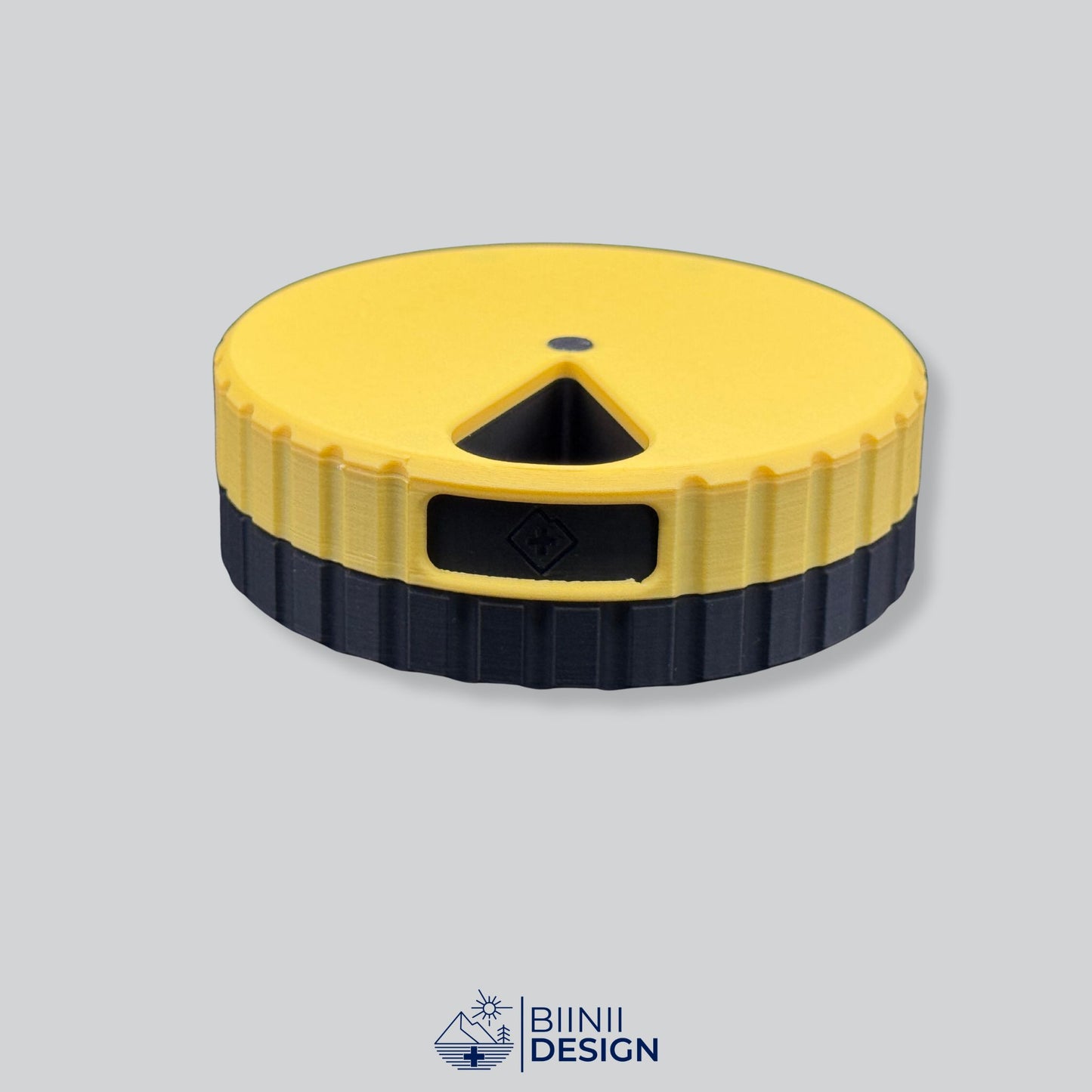 Yellow lid contrasting with black base. Round magnetic pill organizer.