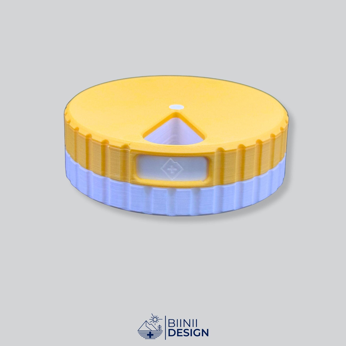 Yellow lid contrasting with white base. Round magnetic pill organizer.