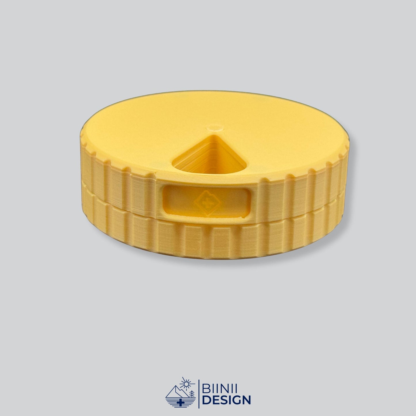 Monochrome yellow round magnetic 7-day pill organizer.