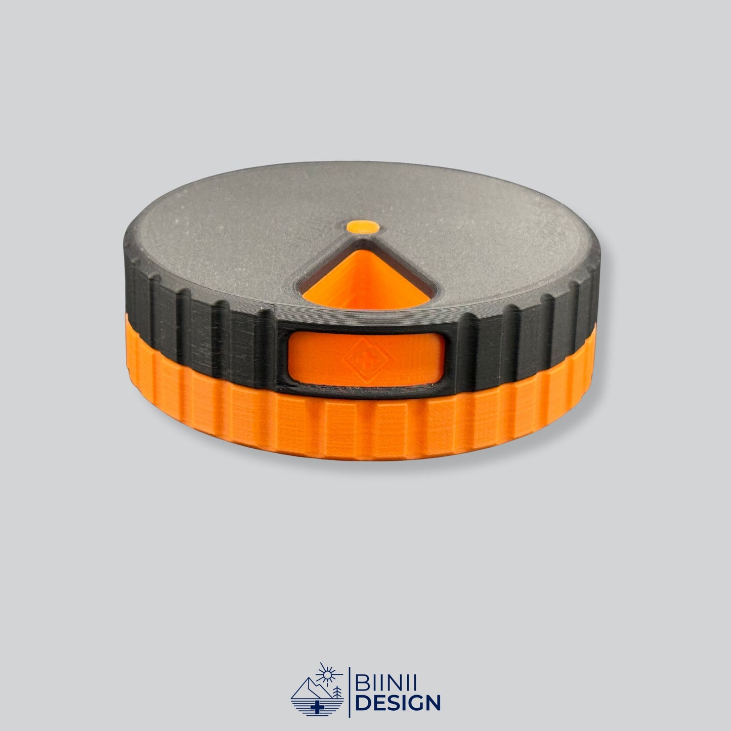 Black lid contrasting with the orange base on the modern round magnetic weekly pill box.