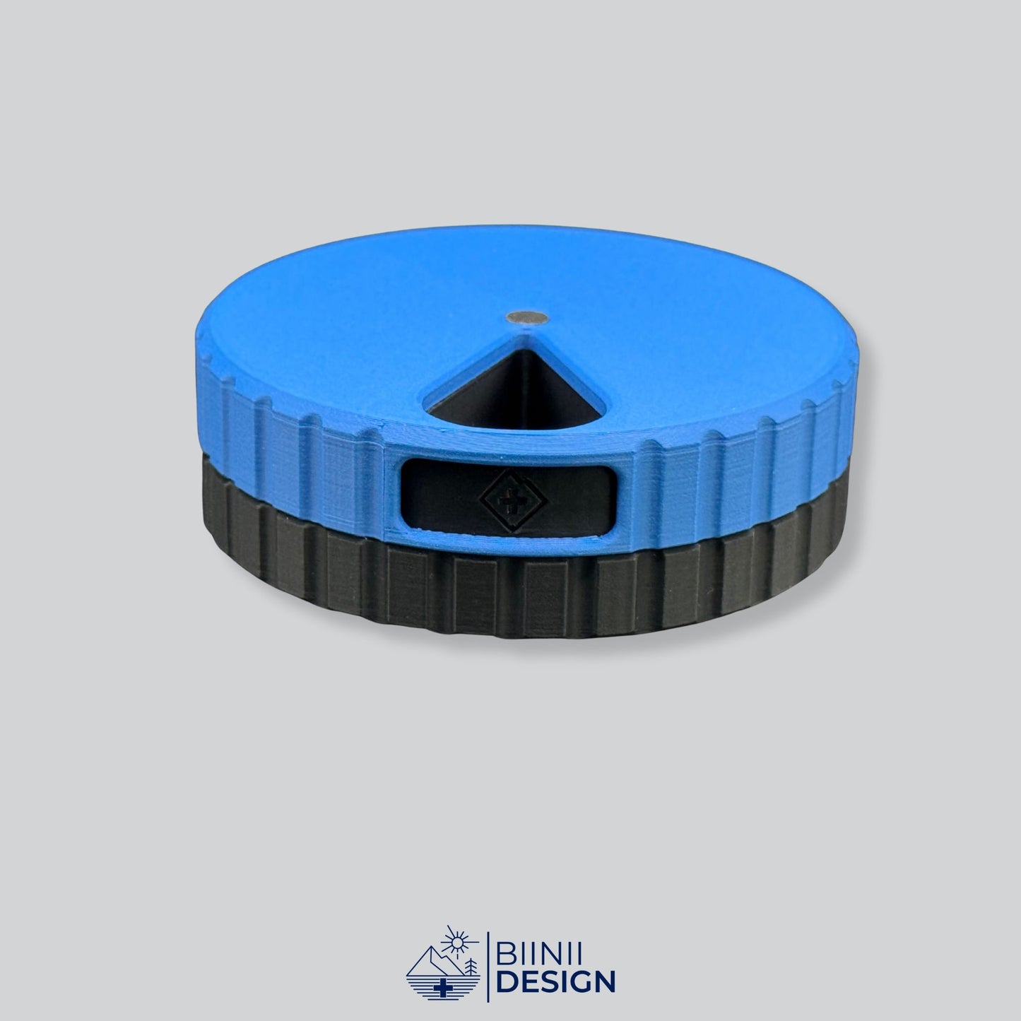 Blue lid contrasting with the black base on the magnetic round 7-day pill organizer.