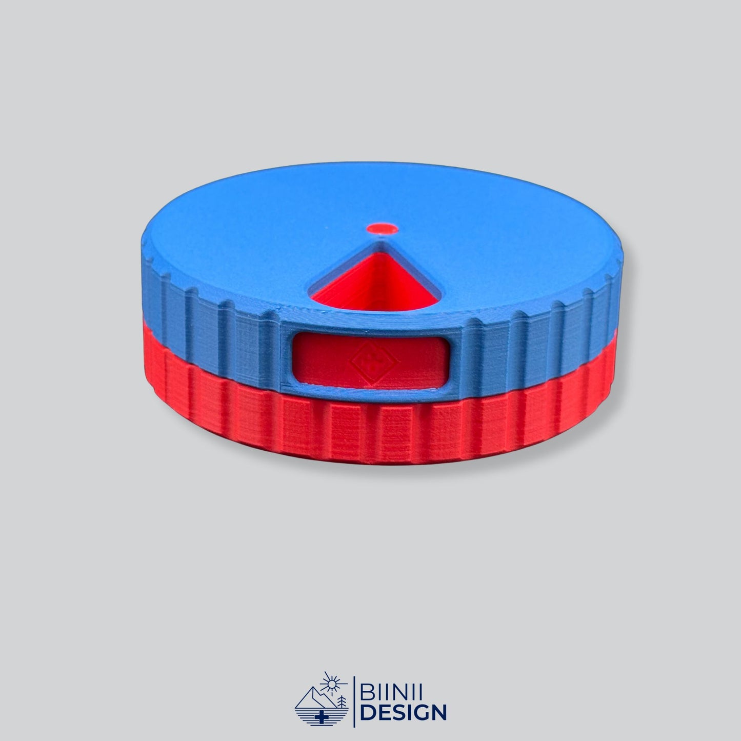 Blue lid contrasting with the bright red base on the magnetic round pill organizer.