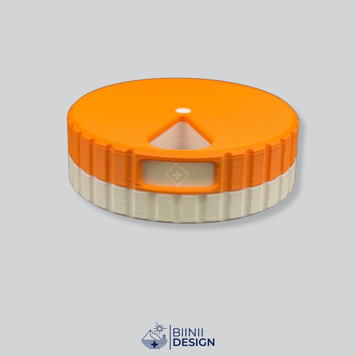 Orange lid contrasting with the white base on the round magnetic weekly organizer.