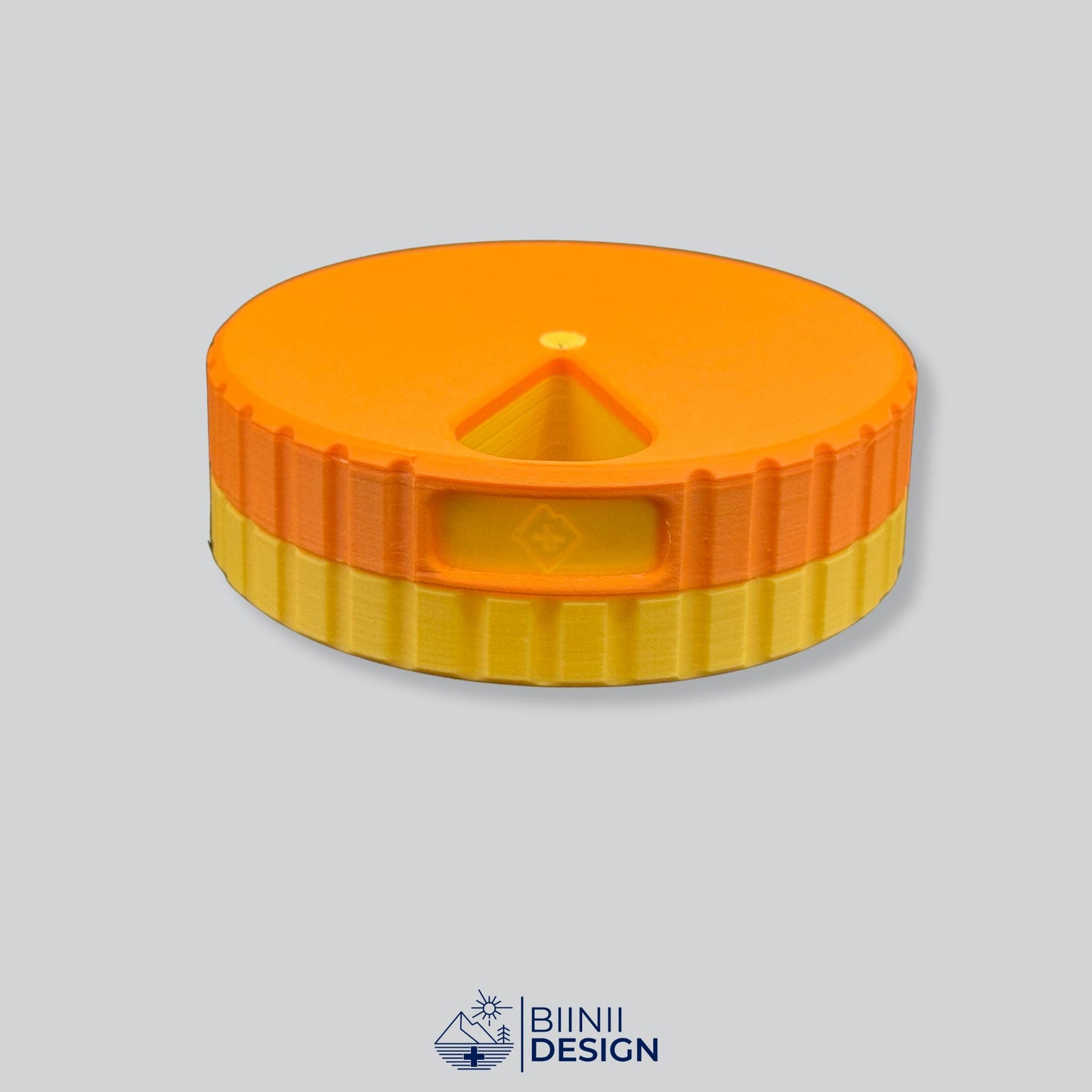Orange lid contrasting with the yellow base on the round magnetic pill organizer.