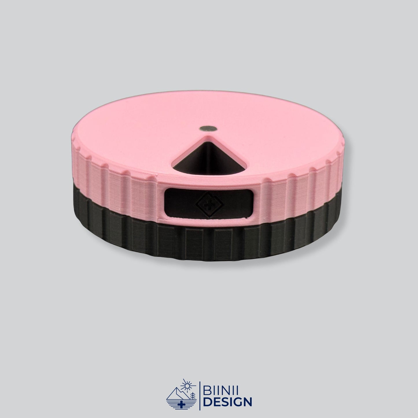 Pink lid contrasting with the black base on the magnetic round 7-day pill organizer.