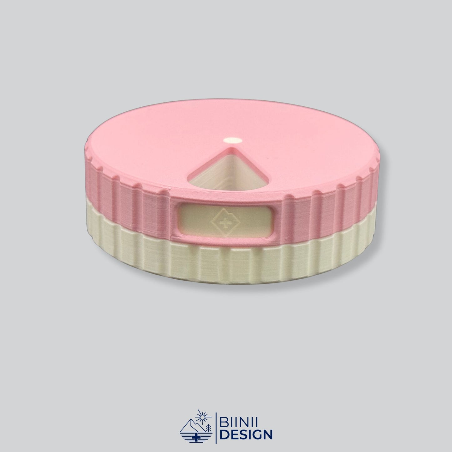 Pink lid contrasting with the white base on the round magnetic 7-day organizer.