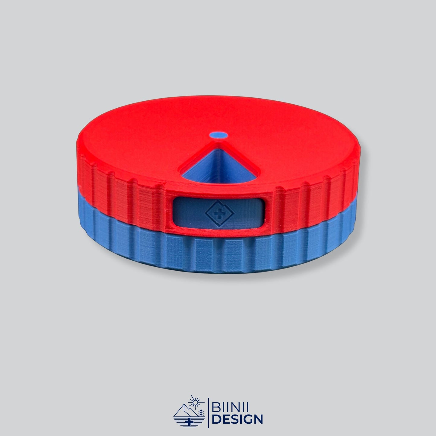 Red lid contrasting with the blue base on the round magnetic weekly pill box.