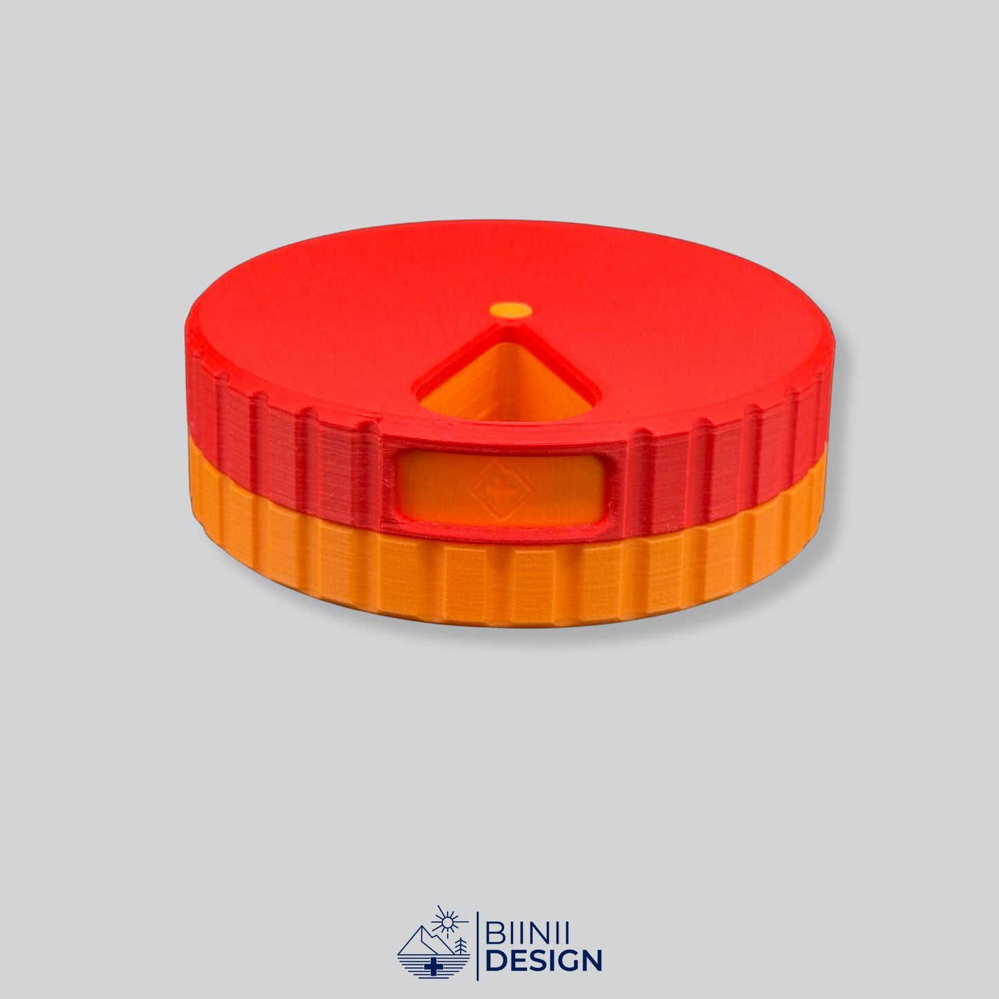 Red lid contrasting with the orange base on the round magnetic pill organizer.