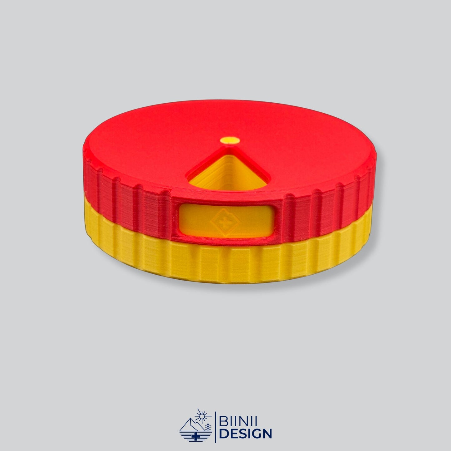 Red lid contrasting with the yellow base on the round magnetic pill case.