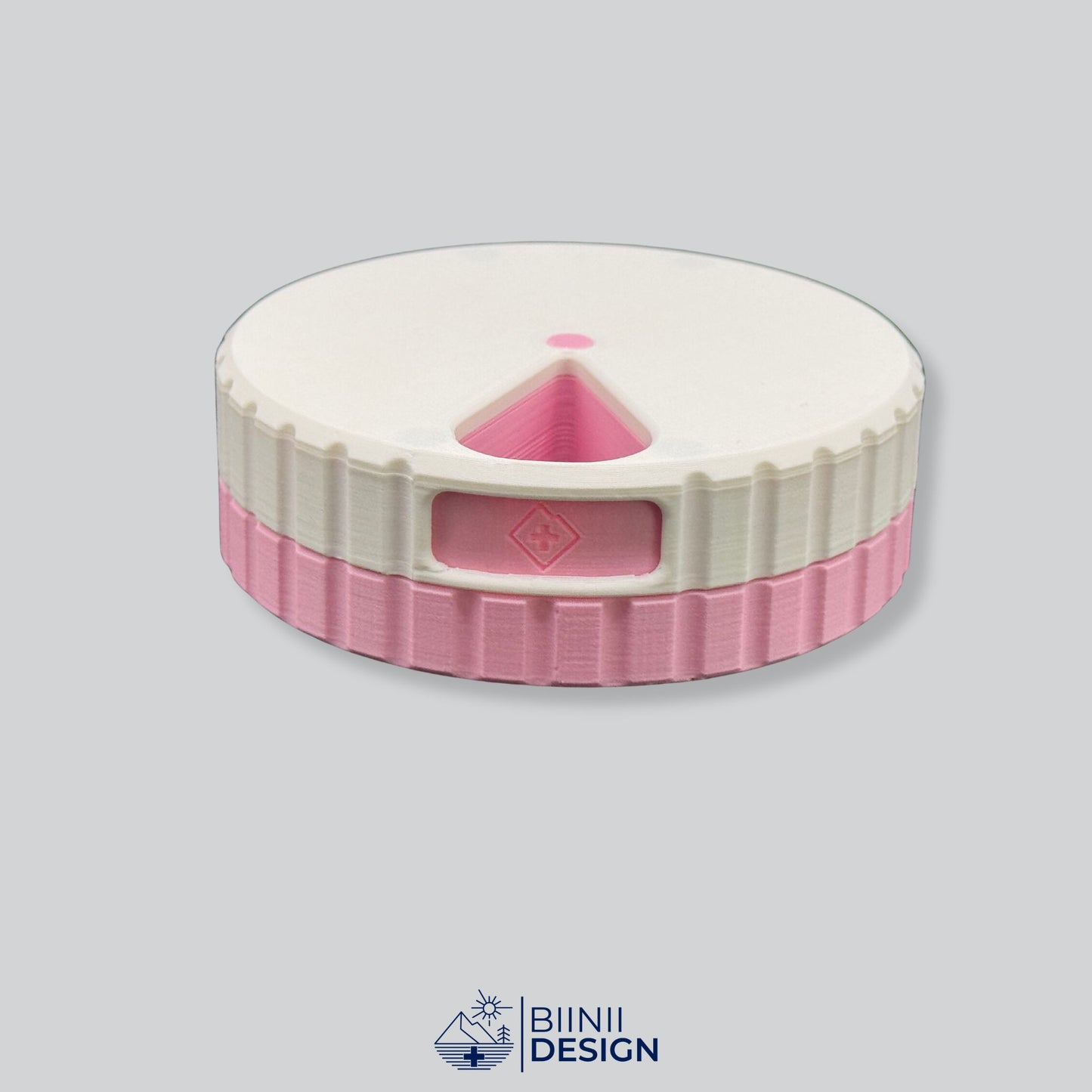White lid contrasting with the pink base on the round magnetic 7-day pill case.