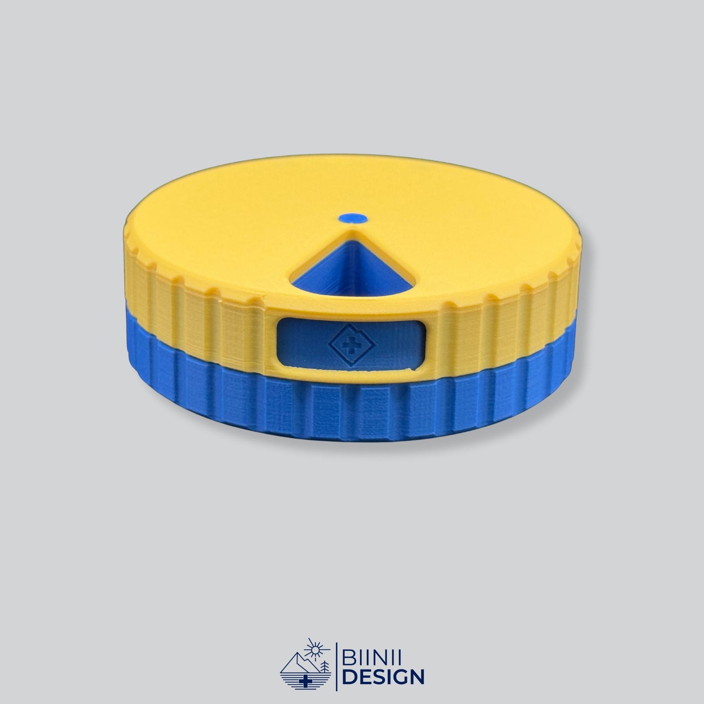 Yellow lid contrasting with the blue base on the round magnetic pill organizer.