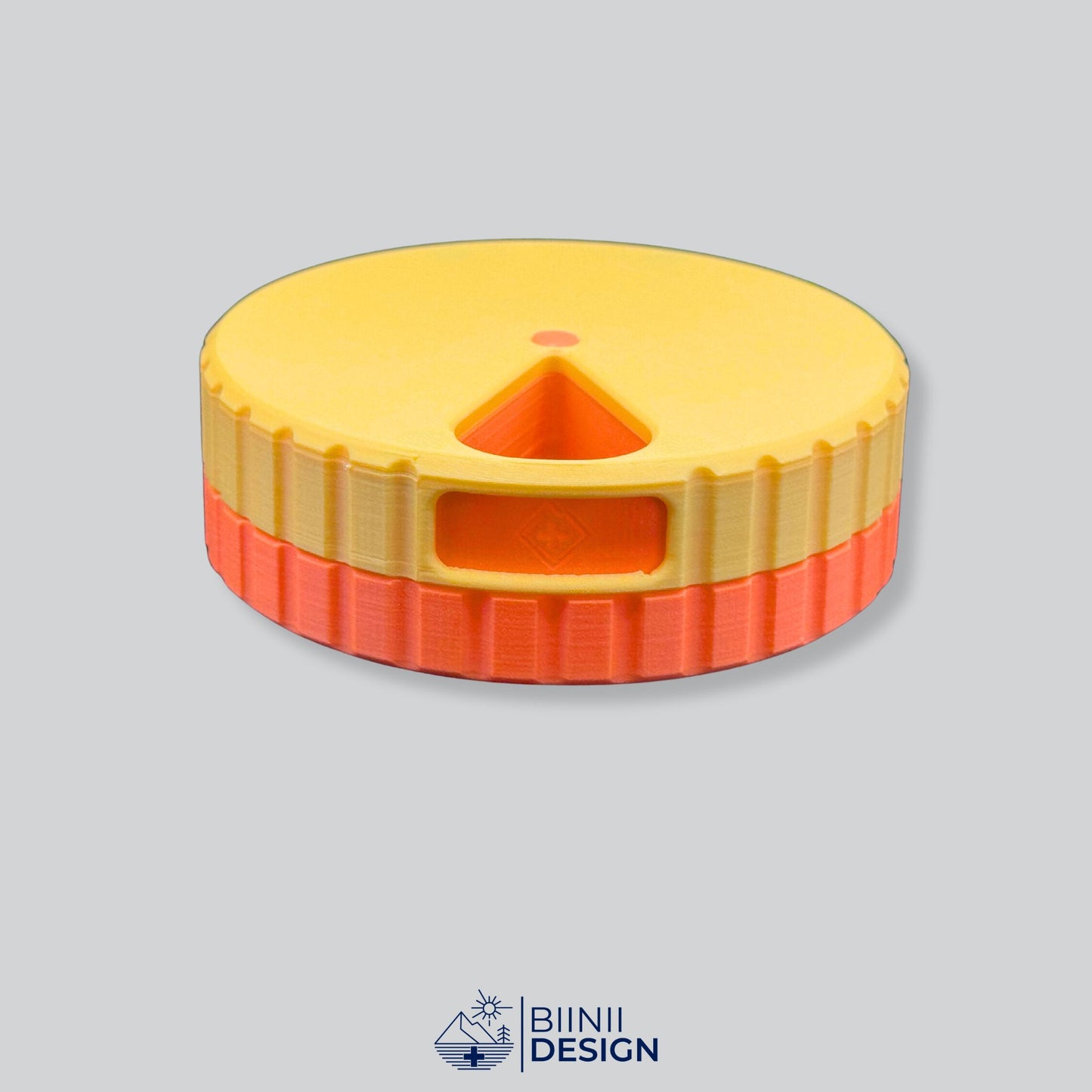 Yellow lid contrasting with the orange base on the round magnetic pill organizer.