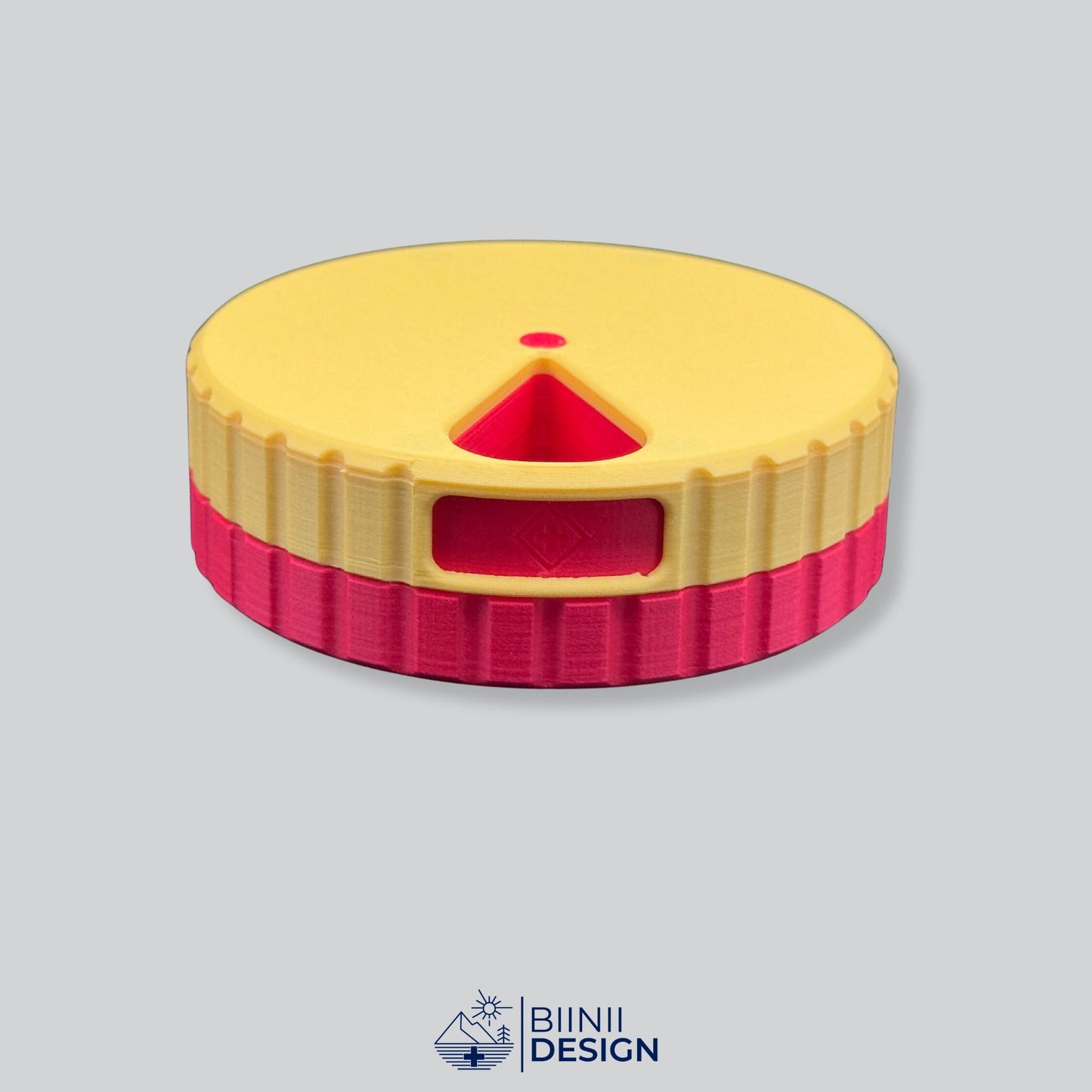 Yellow lid contrasting with the red base on the round magnetic pill case.