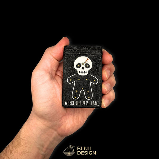 Healing Voodoo pill organizer held in hand for scale. Compact mystic design with a secure slide closure. Ideal for daily healing routines.