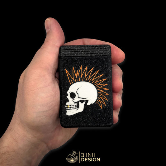 Close-up of the Punk Skull pillbox in galaxy black held in hand, showing compact size and fine detail. Golden tooth and copper mohawk add visual contrast. Keywords: punk pillbox, skull pill case, small pill organizer, galaxy black, 3D printed, compact travel pillbox
