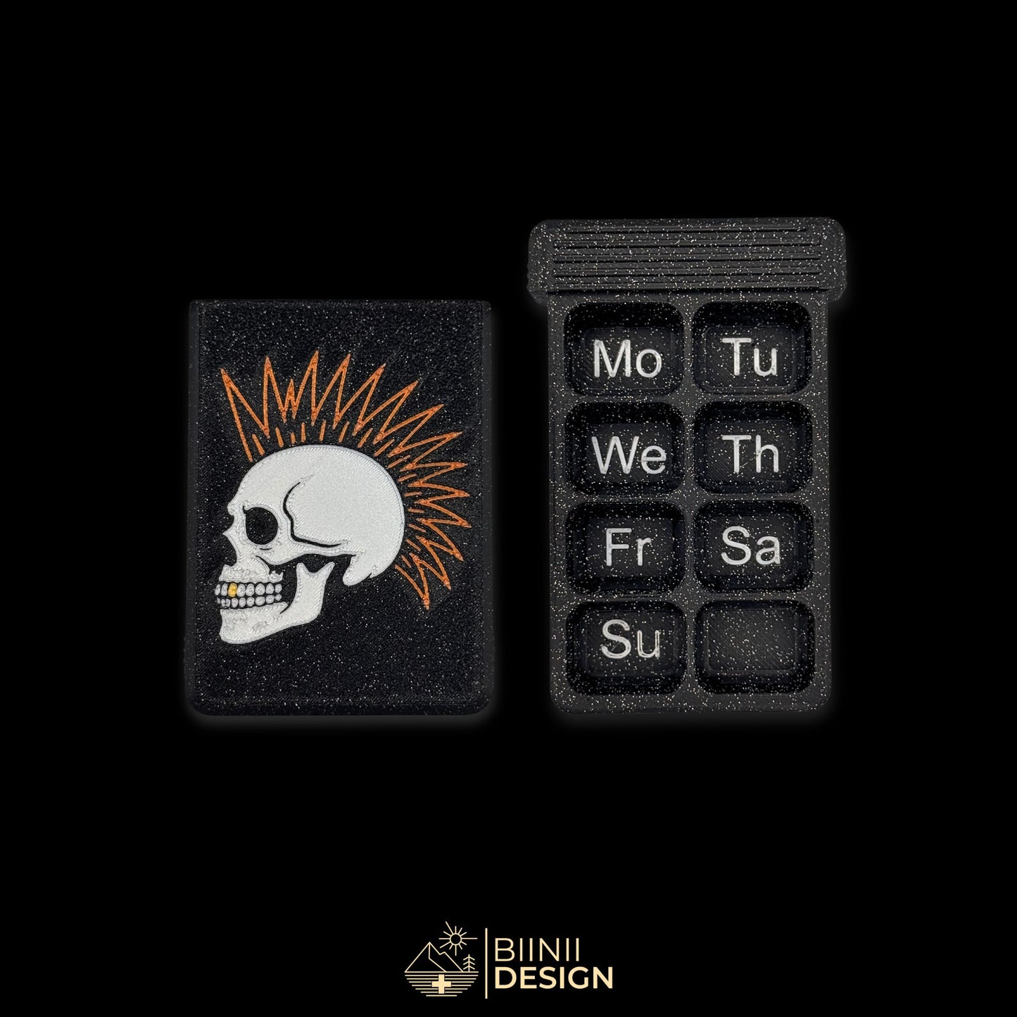 7-day punk skull pillbox in galaxy black with Monday-start layout, Swiss-made with golden tooth gothic design.
Keywords: pillbox, pill organizer, weekly pill case, artistic