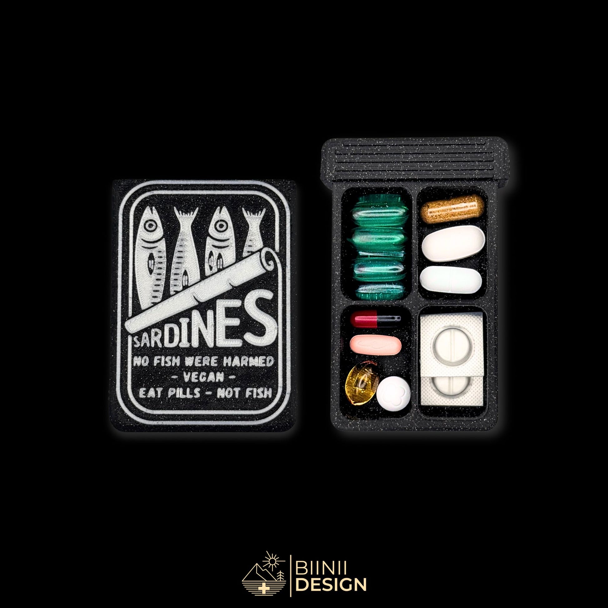 Flat sardines-style pill box with 4 compartments, open with various pills. Compact and unique daily organizer in galaxy black.