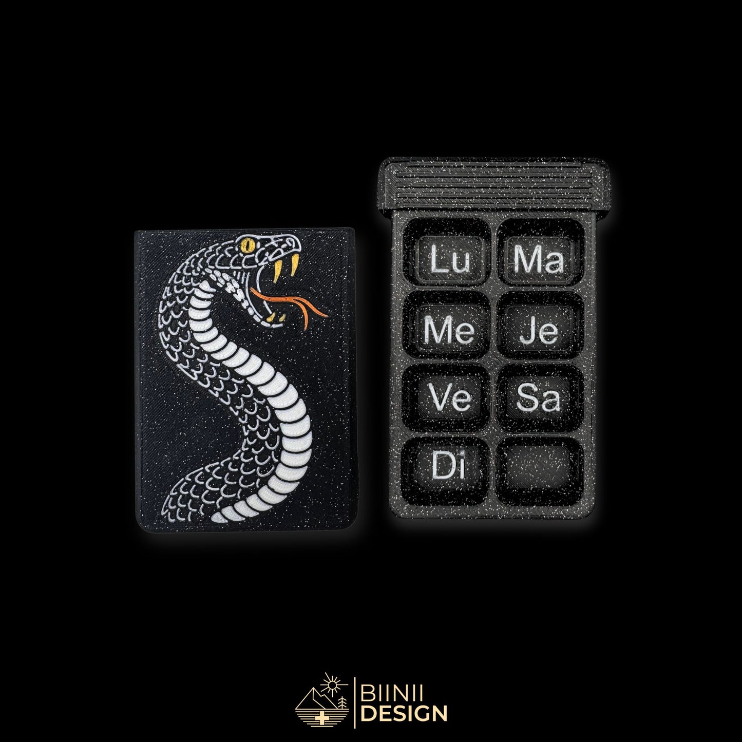 Weekly snake pillbox in galaxy black, French Monday-start layout, Swiss-made compact organizer with serpent design.
Keywords: pillbox, pill organizer, weekly pill case, artistic