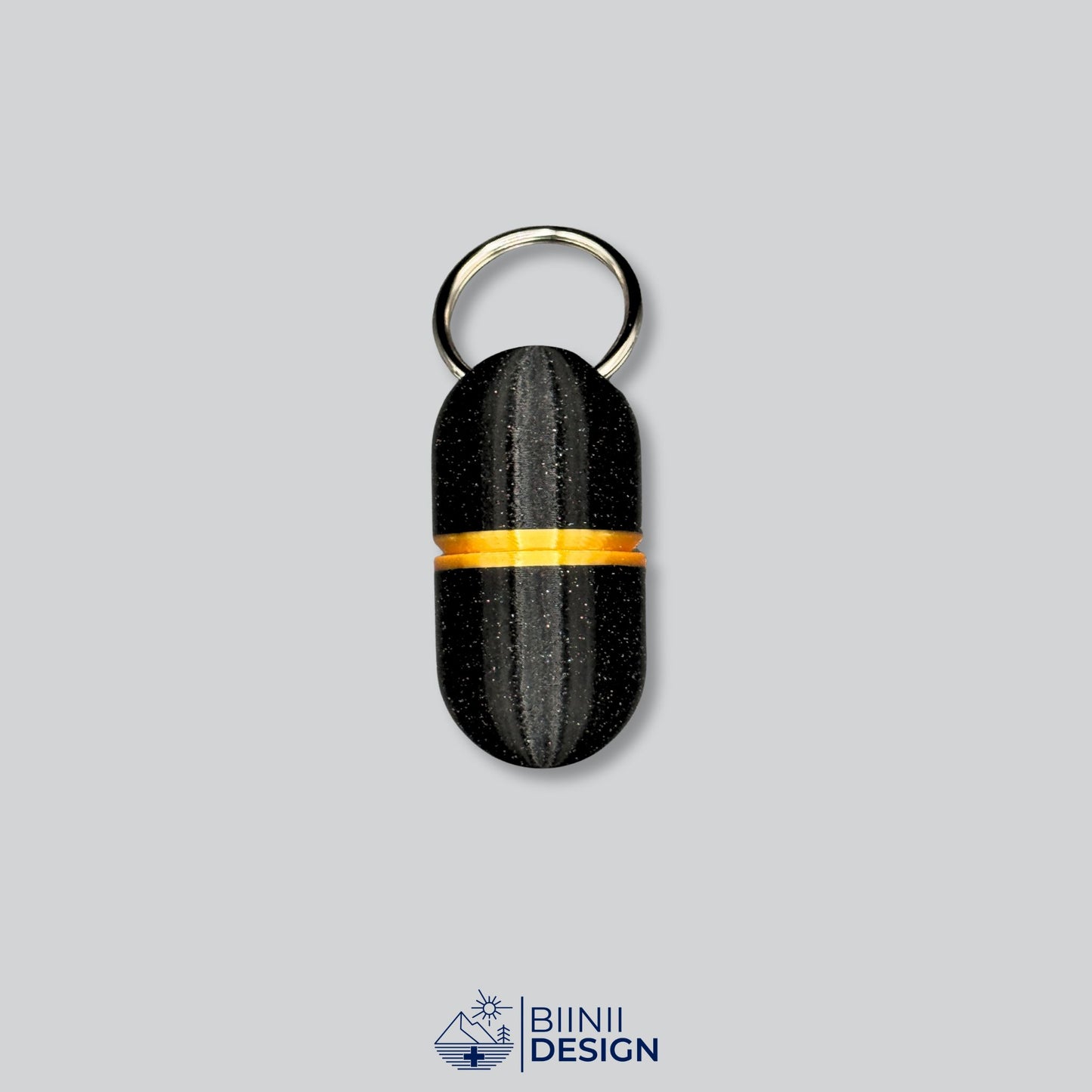 Keychain-sized deluxe pillbox with black galaxy body and gold accent, ideal for vitamins, painkillers, or supplements.
Keywords: travel pill holder, deluxe keyring capsule case, compact pill organizer, Biinii Design